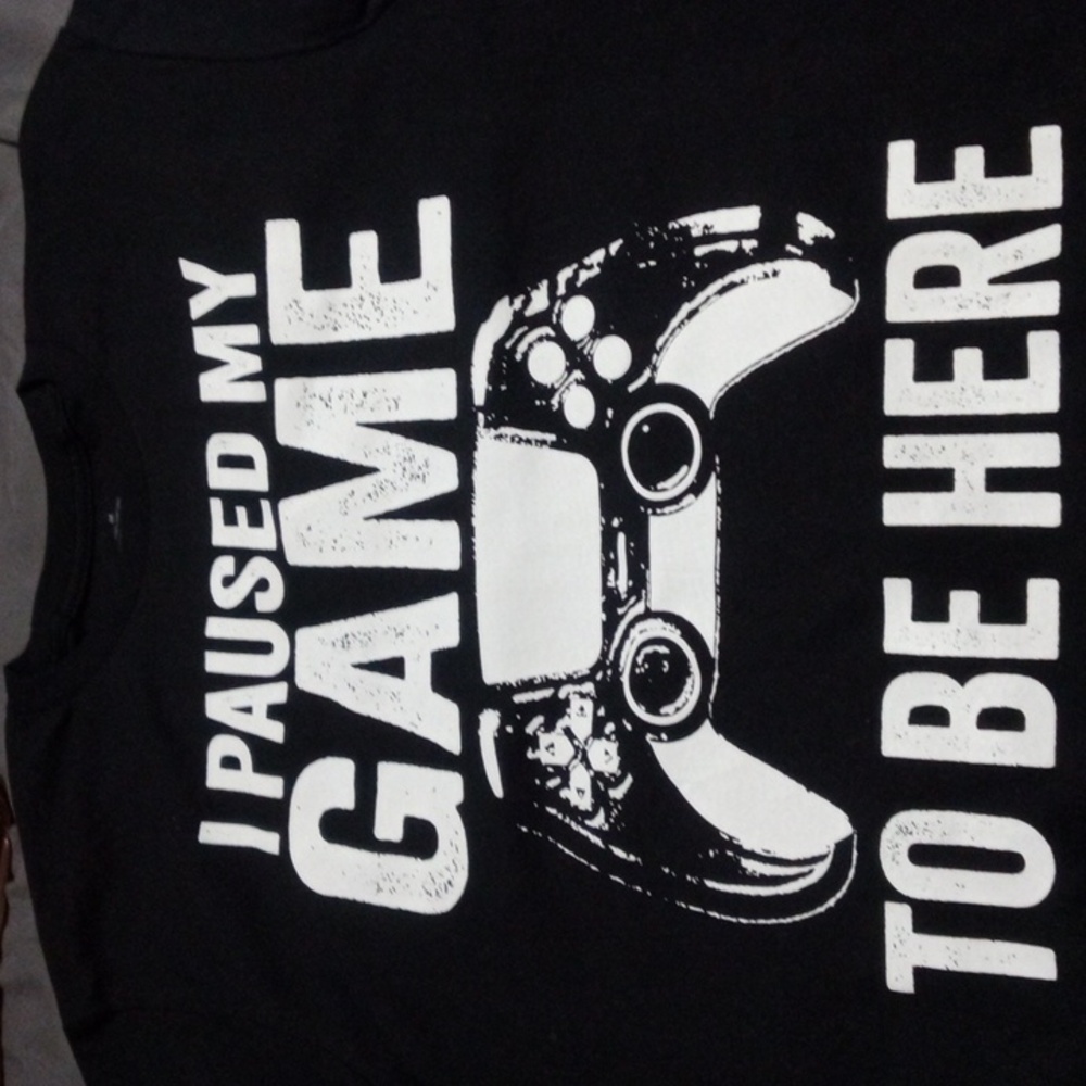 Size medium black Tshirt. Says I paused my game for this...